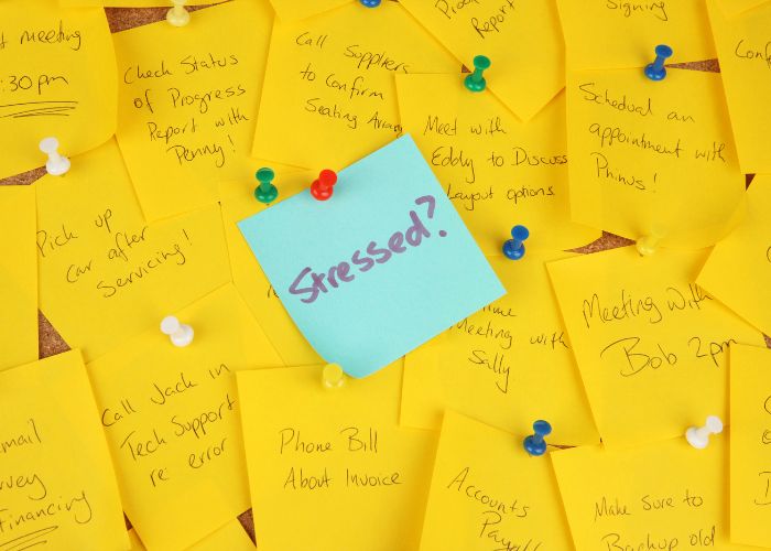 A blue sticky note with the words "stressed?"