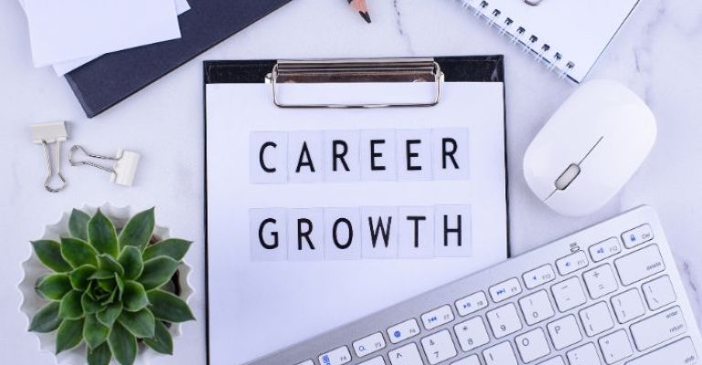 A clipboard with the words "career growth" on it.